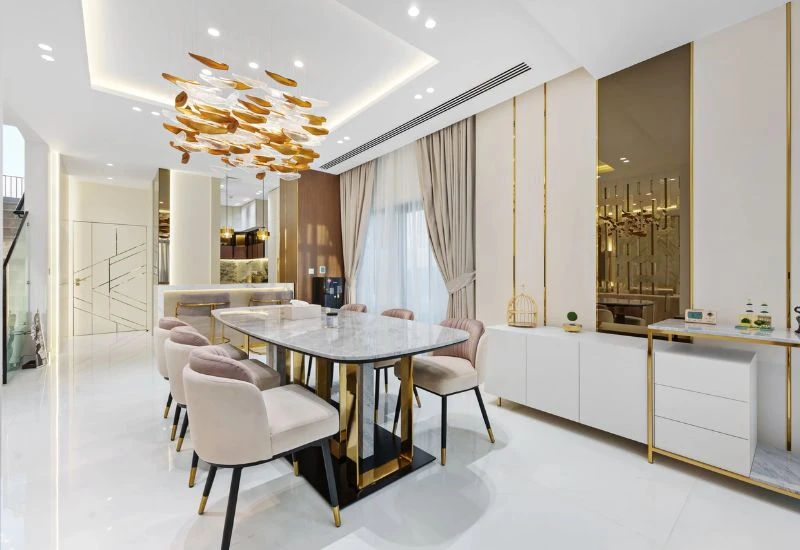 Luxury dining room renovation with gold accents Dubai.
