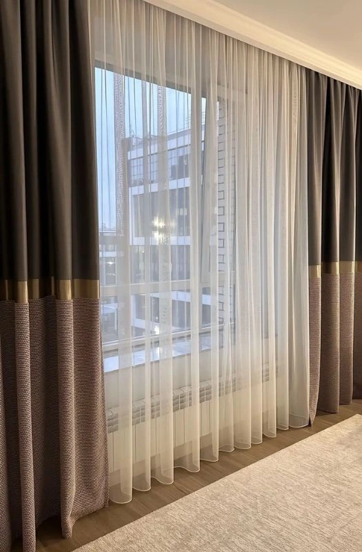 Brown eyelet curtains with white sheer fabric.