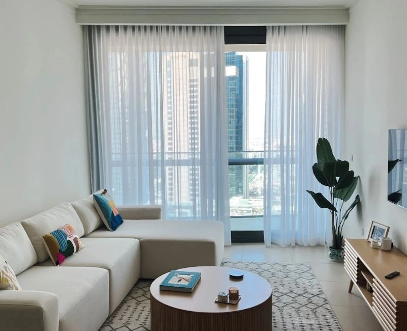 Modern white sheer curtains for apartment living room.