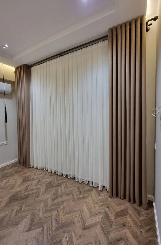 Modern white sheer curtains for bedroom renovation.