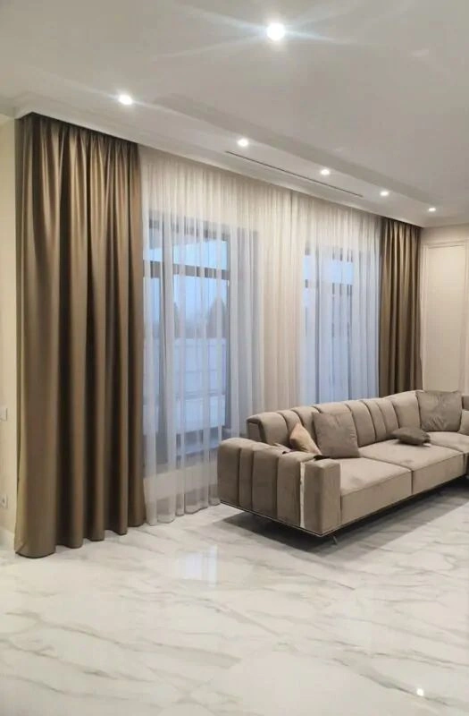 Luxury silk curtains with white sheer fabric layers.