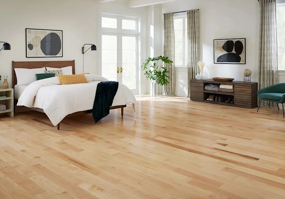 Luxury bedroom renovation with premium light wood flooring.