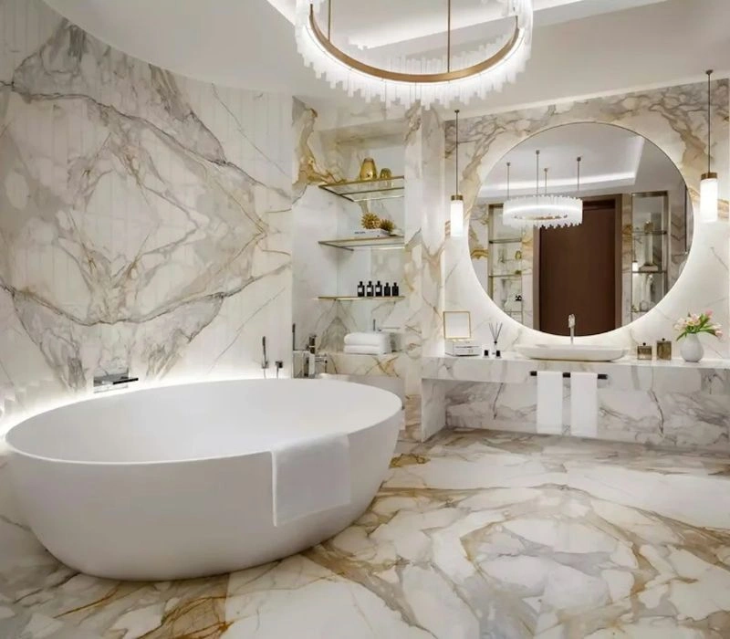 Luxury marble bathroom renovation with round backlit mirror.