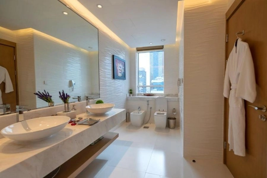 Modern white bathroom renovation with city view.