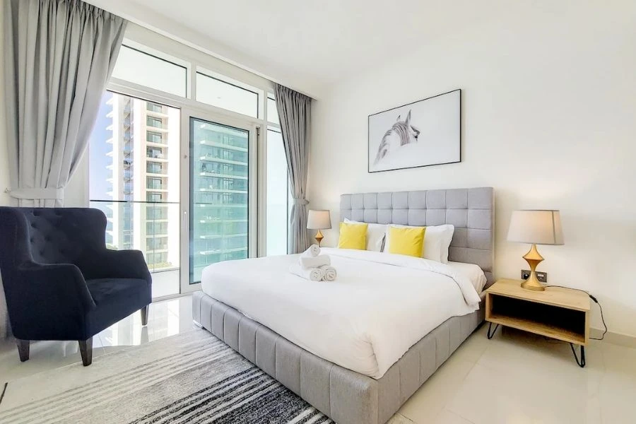 Clean bedroom renovation with grey headboard.