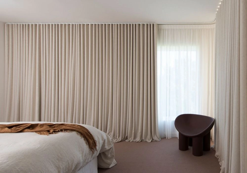 Automatic motorized curtains for large villa windows.