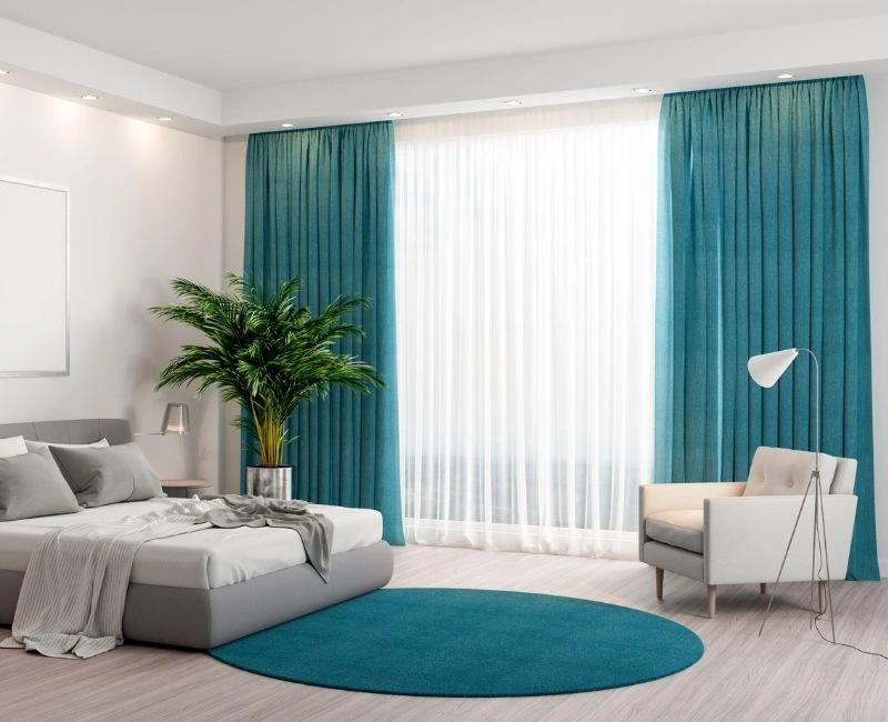Teal blue curtains for modern bedroom window decor.