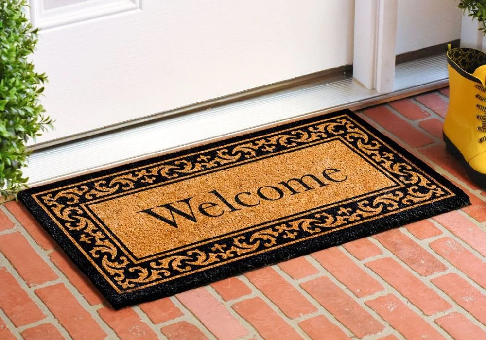 Heavy-duty coir entrance door mat for dust control.