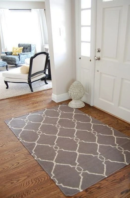 Grey patterned indoor floor mat in living room.