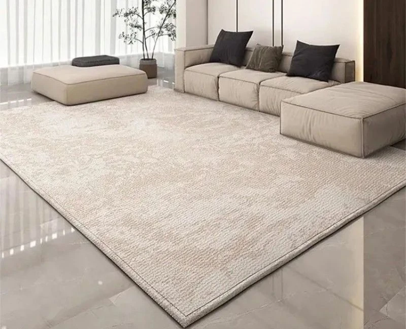 Minimalist cream-colored area rug in a modern living room setting.