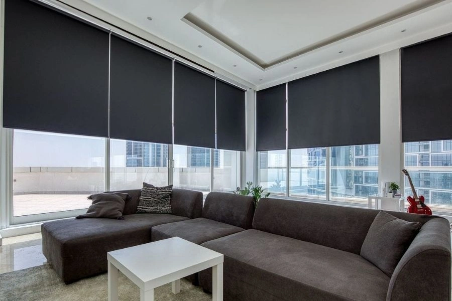 Blackout roller blinds for modern Dubai penthouse windows.