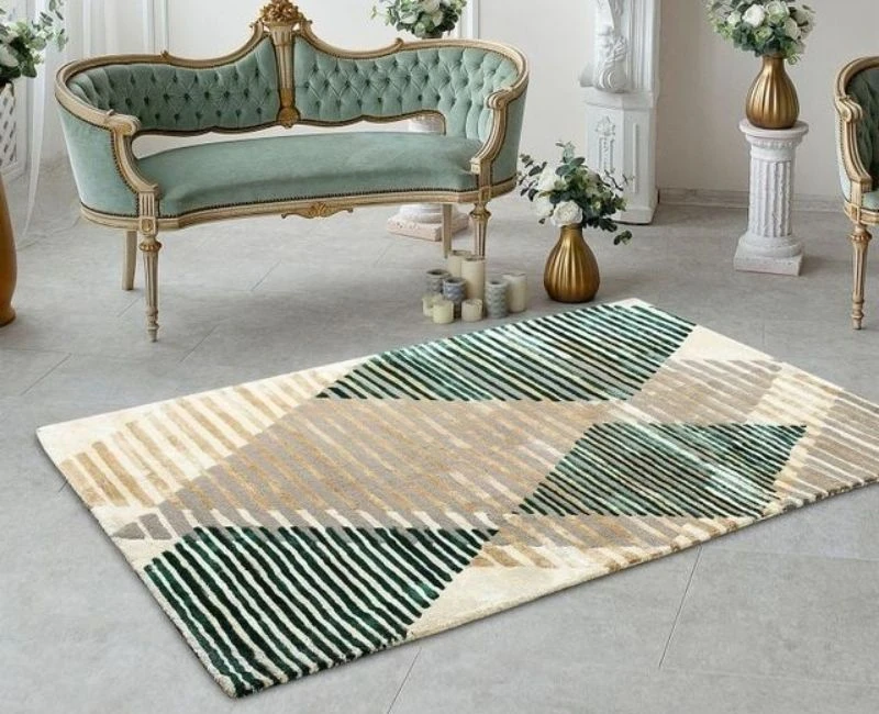 Modern geometric area rug with green and beige patterns in a luxury setting.