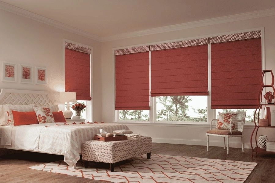 Red roman blinds for elegant bedroom windows in Dubai.