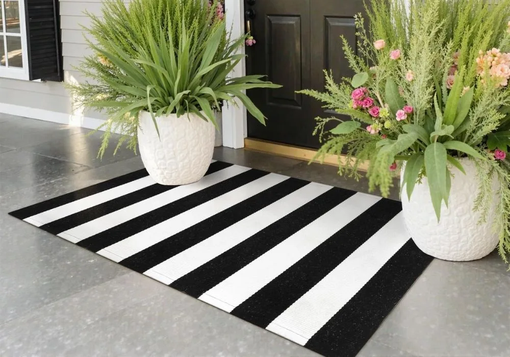 Black and white striped outdoor entrance floor mat.