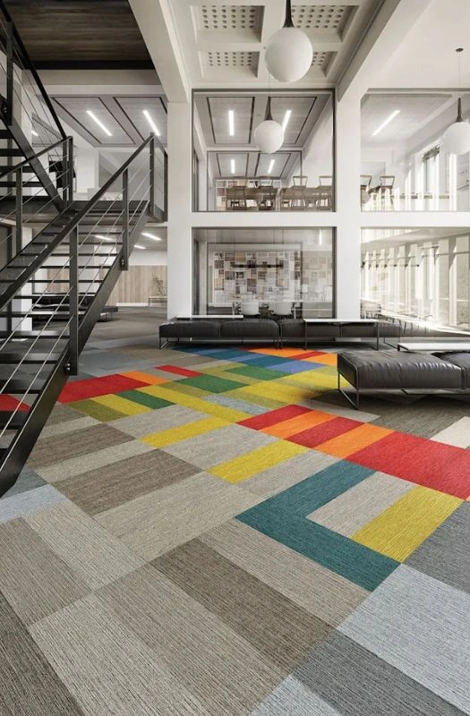 Colorful geometric carpet tiles in modern Dubai office.