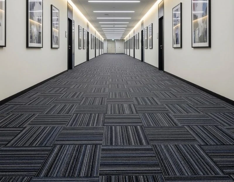 Long office hallway with grey carpet tiles