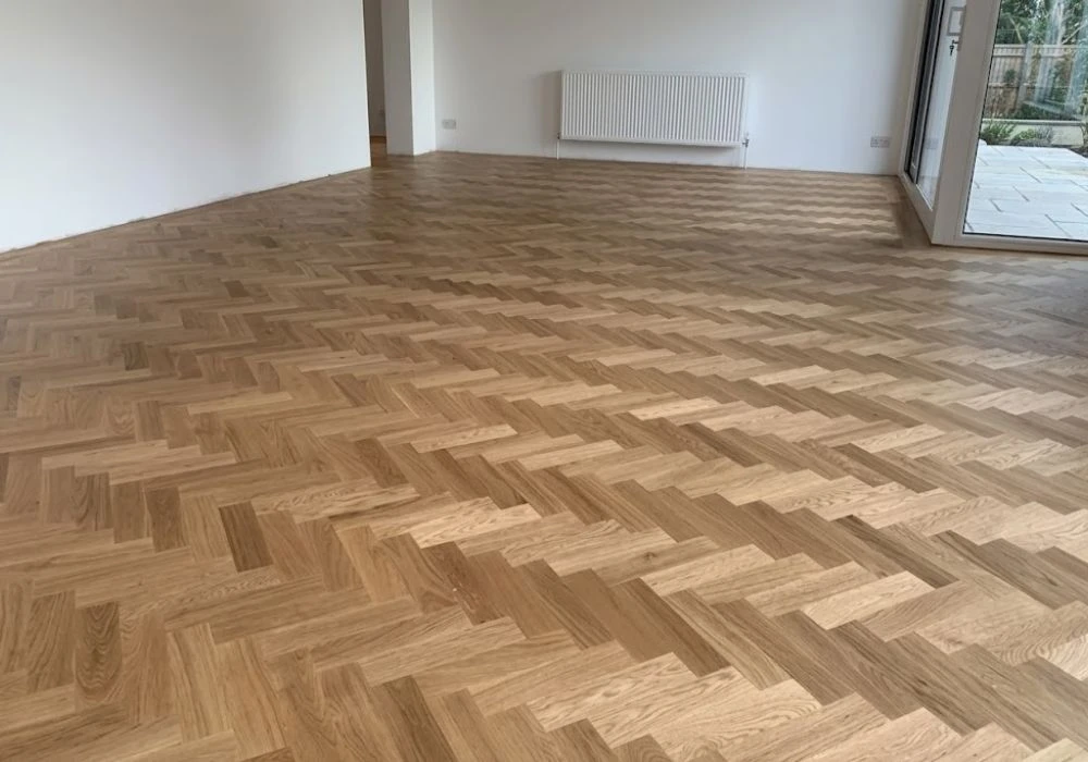 Empty room interior with oak parquet flooring