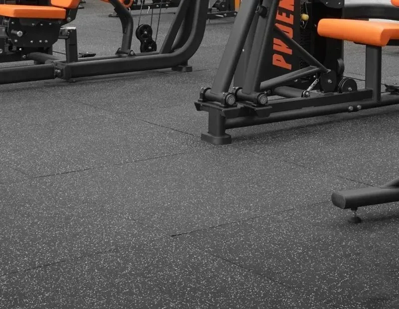 Gym rubber flooring tiles under fitness equipment