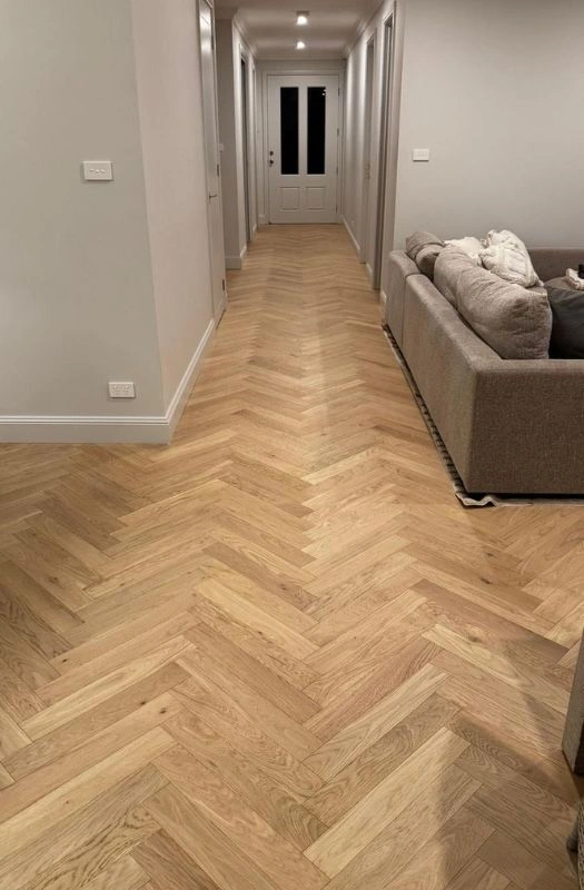 Light oak herringbone floor in long corridor