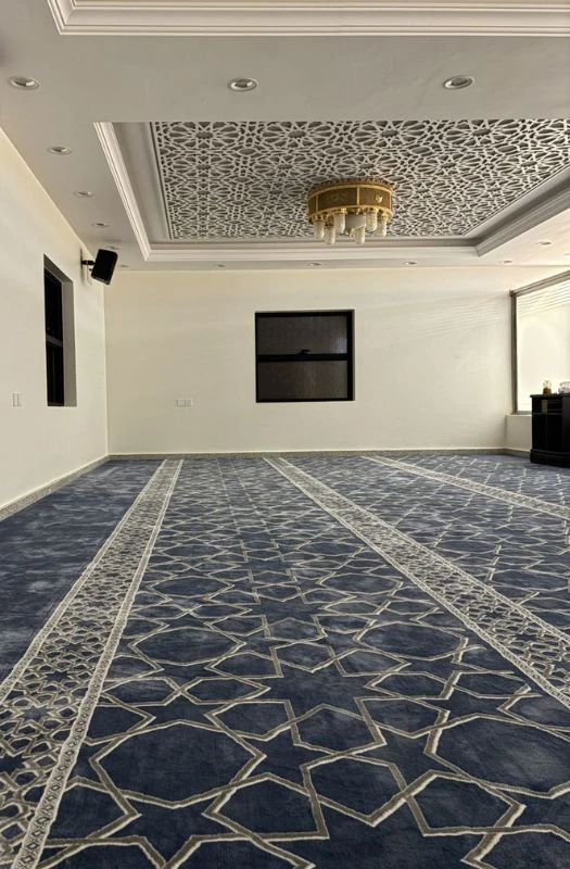 Navy blue geometric patterned mosque carpet in modern interior